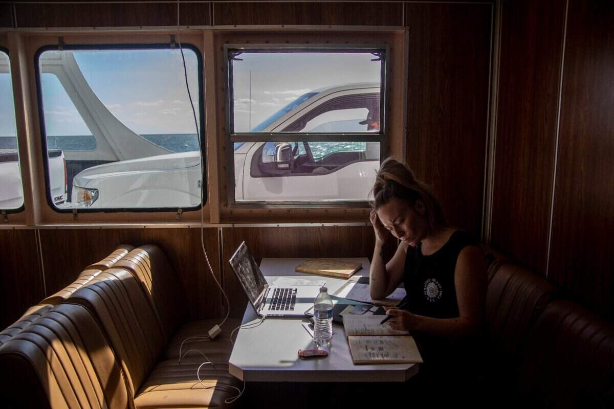Brittney Brady, an interior designer, uses the 2.5-hour-long ferry trip across the Pamlico Sound from Swan Quarter to Ocracoke to catch up on emails and work Tuesday, May 17, 2022.