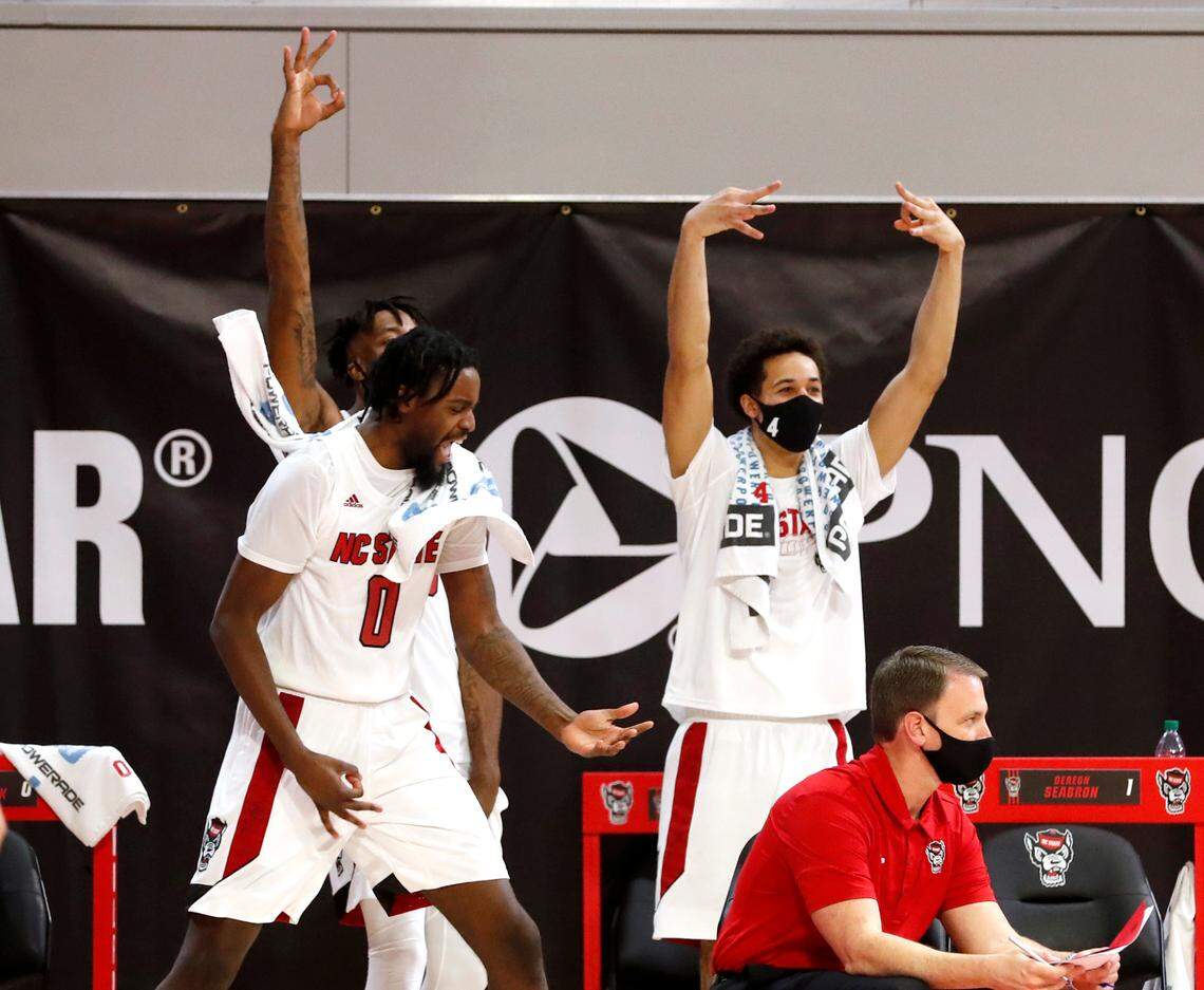 N.C. State’s D.J. Funderburk (0), Manny Bates (15) and Jericole Hellems (4) celebrate after Jaylon Gibson made a three-pointer during the second half of N.C. State’s 95-61 victory over Charleston Southern in the Wolfpack Invitational at Reynolds Coliseum in Raleigh, N.C., Wednesday, Nov. 25, 2020.
