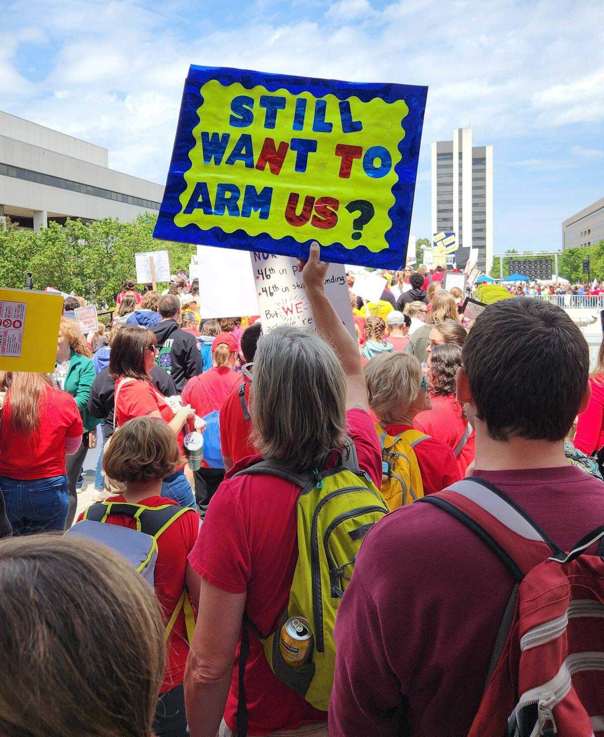 Protesters with signs gather around the Legislature in Raleigh.