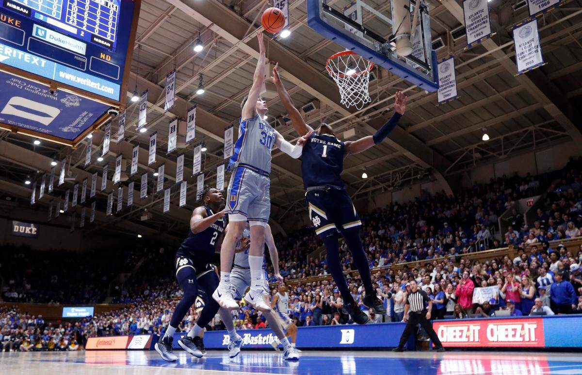Duke’s Kyle Filipowski (30) shoots as Notre Dame’s J.J. Starling (1) defends during Duke’s 68-64 victory over Notre Dame at Cameron Indoor Stadium in Durham, N.C., Tuesday, Feb. 14, 2023.