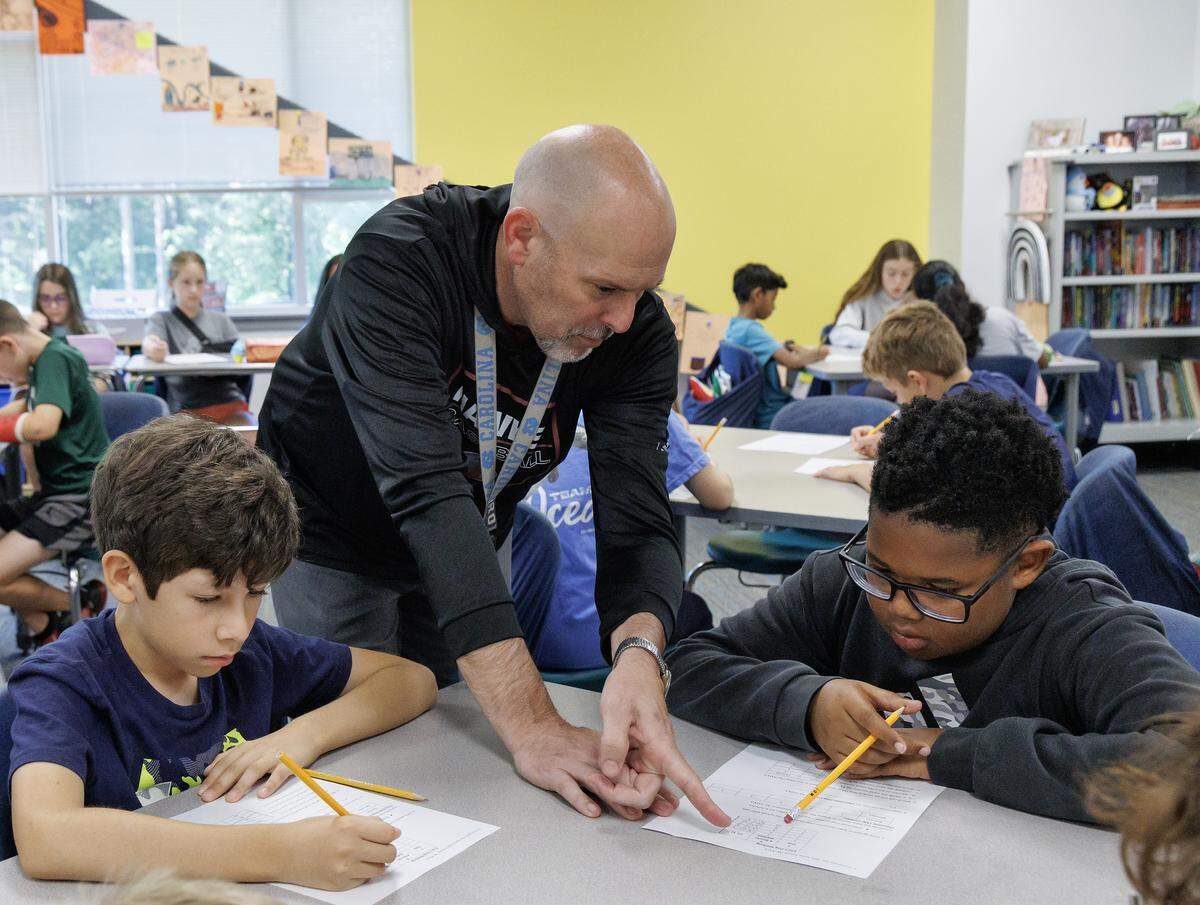 Fifth-grade teacher Chris Bowling talks with students during class at Apex Friendship Elementary School on Tuesday, May 5, 2026, in Apex, N.C.