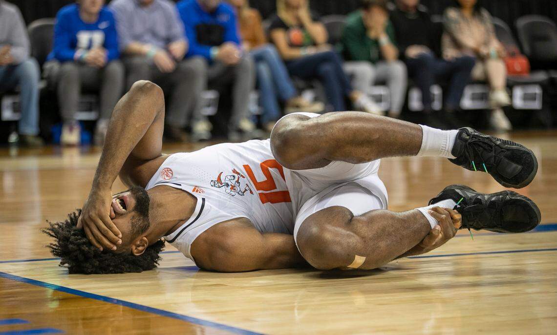 Miami’s Norchad Omier (15) goes down in the court after injuring himself in the opening minutes of play against Duke in the semi-finals of the ACC Tournament on Friday, March 10, 2023 at the Greensboro Coliseum in Greensboro, N.C.