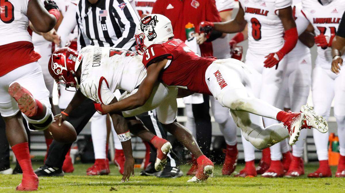 N.C. State linebacker Vi Jones (31) tackles Louisville quarterback Malik Cunningham (3) short of the first down during the second half of N.C. State’s 28-13 victory over Louisville at Carter-Finley Stadium in Raleigh, N.C., Saturday, October 30, 2021.