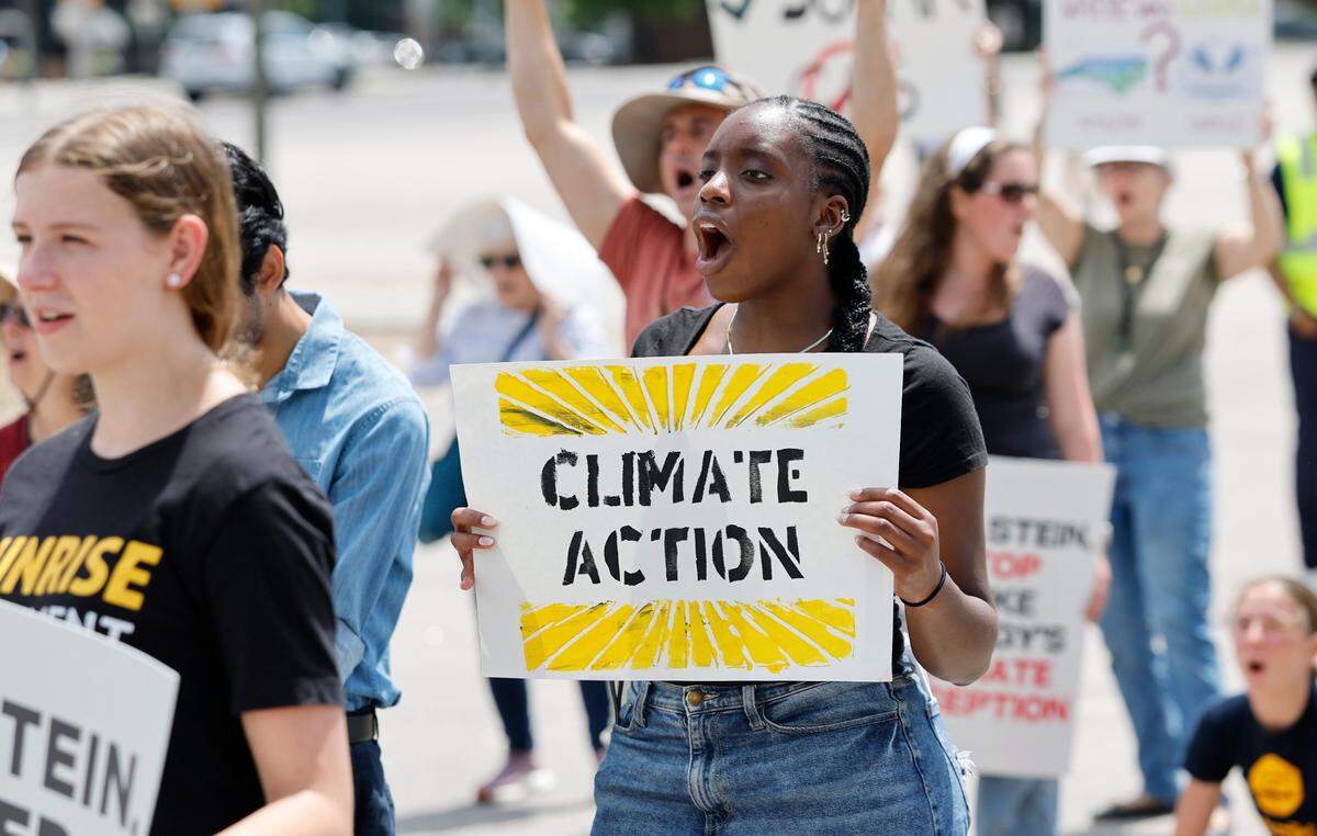 UNC student Amy Onyinye Okonkwo cheers on a speaker during a rally and march organized by NC WARN near the N.C. Executive Mansion in Raleigh, N.C., Saturday, April 26, 2025. Around 85 people gathered to pressure Gov. Josh Stein to speak out against Duke Energy and push the state’s monopoly utility to embrace renewable energy.
