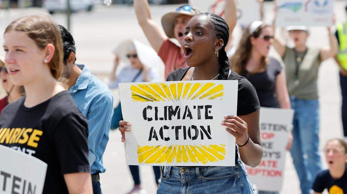 UNC student Amy Onyinye Okonkwo cheers on a speaker during a rally and march organized by NC WARN near the N.C. Executive Mansion in Raleigh, N.C., on Saturday, April 26, 2025. Around 85 people gathered to pressure Gov. Josh Stein to speak out against Duke Energy and push the state’s monopoly utility to embrace renewable energy.
