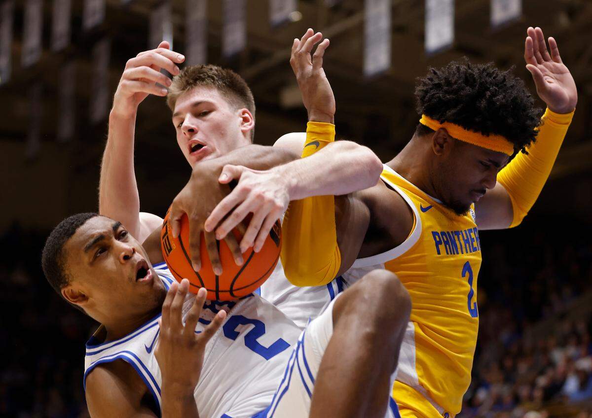 Duke’s Jaylen Blakes and Kyle Filipowski battle with Pittsburgh’s Blake Hinson for a loose ball during the first half of a men’s basketball game at Cameron Indoor Stadium on Wednesday, Jan. 11, 2023, in Durham, N.C.