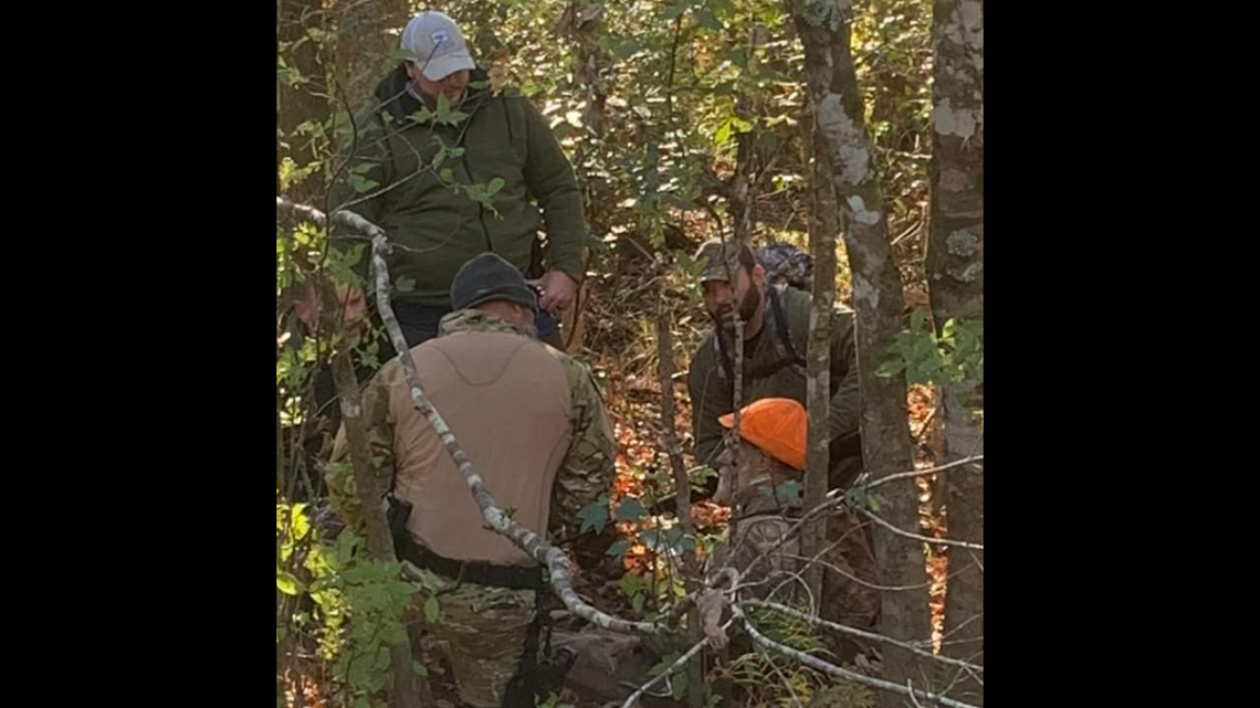 Michael Edward Abernethy, 56, is surrounded by rescuers after he was found early Tuesday, Nov. 23, in the Green Swamp.