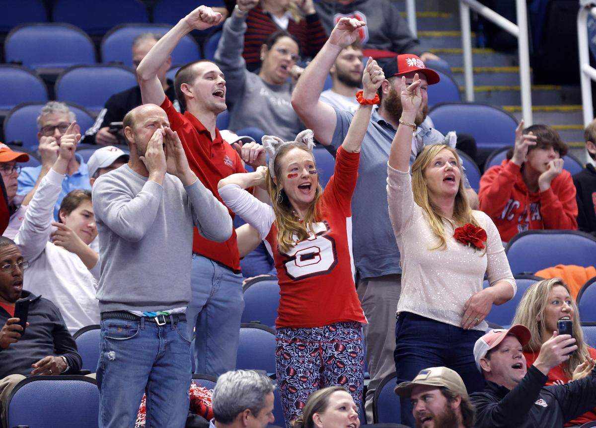 N.C. State fans cheer on the Wolfpack late in the second half of N.C. State’s 97-77 victory over Virginia Tech in the second round of the ACC Men’s Basketball Tournament in Greensboro, N.C., Wednesday, March 8, 2023.
