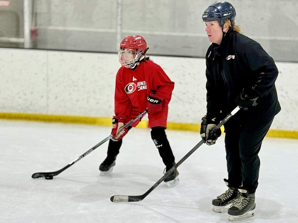 Junior Canes coach Jessica Hughes works with 10U Red player Emily Quicksell during a practice at Wake Competition Center in Morrisville, N.C., on Thursday, Jan. 29, 2026.