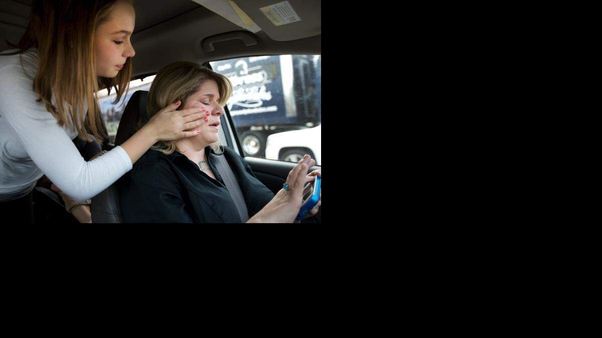‘Don’t cry, Mommy,’ Holly Johnson tells Kristy Johnson as she wipes tears from her mother’s face after departing the airport. 
