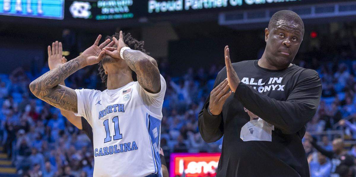 N.C. Central head coach LeVelle Moton calls a time-out as he steps away from North Carolina guard Jonathan Powell (11), who reacts after sinking a three-point basket in the first half on Friday, November 14, 2025 at the Smith Center in Chapel Hill, N.C.