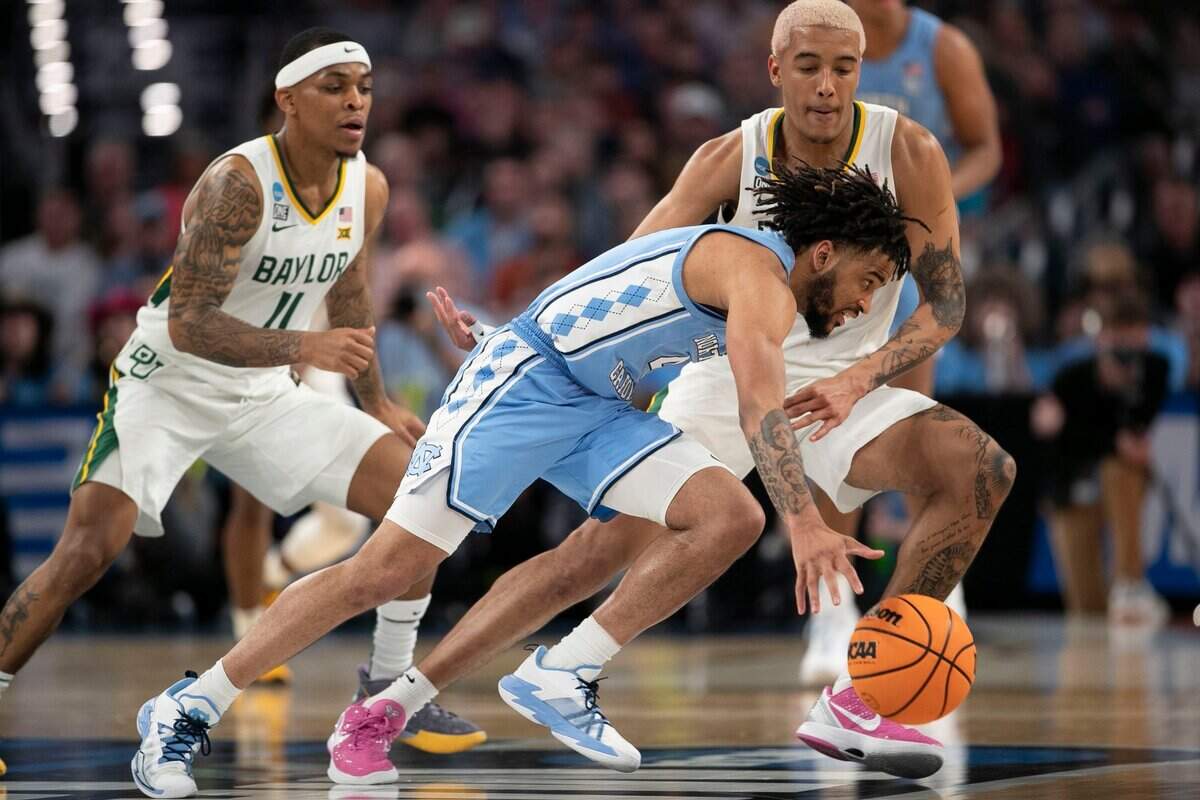 North Carolinas R.J. Davis (4) drives against Baylors Jeremy Sochan (1) in the second half on Saturday, March 19, 2022 during the NCAA Tournament at Dickies Arena in Ft. Worth, TX.