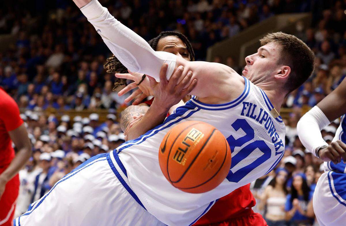 Duke’s Kyle Filipowski (30) fights for the ball with Louisville’s Kaleb Glenn (10) during the first half of Duke’s game against Louisville at Cameron Indoor Stadium in Durham, N.C., Wednesday, Feb. 28, 2024.