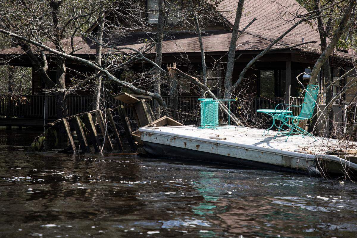 Homes on River Bend Drive in Burgaw, N.C., all of which are on stilts, are still sitting under more than 10 feet of water on Sunday, Sept. 23, 2018. 