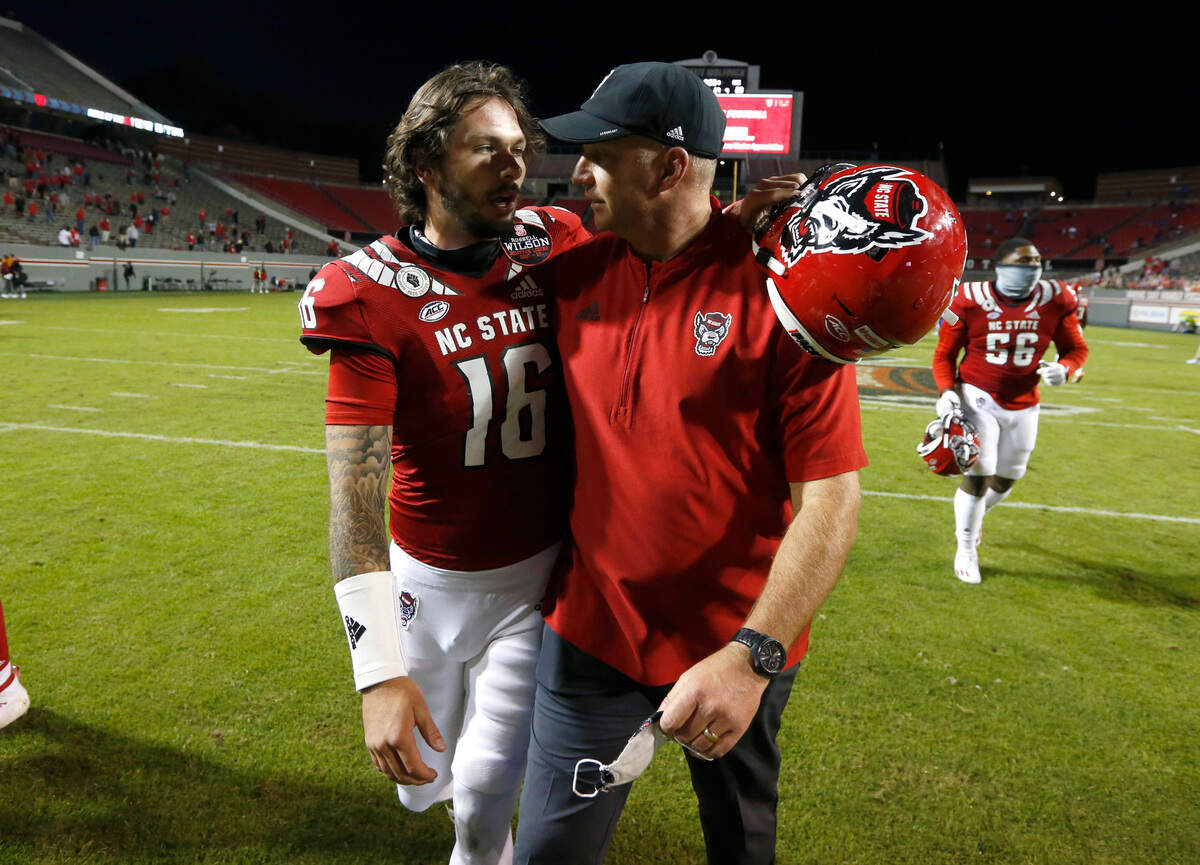 N.C. State head coach Dave Doeren talks with quarterback Bailey Hockman (16) after N.C. State’s 31-20 victory over Duke at Carter-Finley Stadium in Raleigh, N.C., Saturday, Oct. 17, 2020.