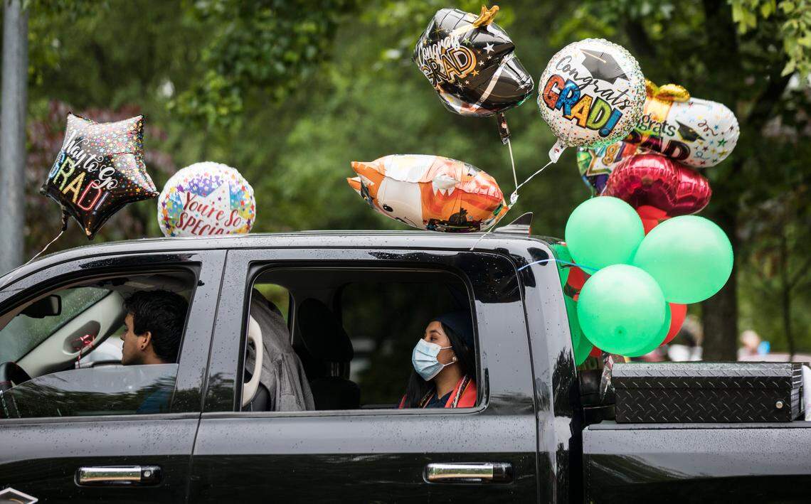 Edilia Epitacio arrives to the socially distanced graduation ceremony at Southeast Raleigh High School in a truck covered in balloons on Wednesday, May 27, 2020.