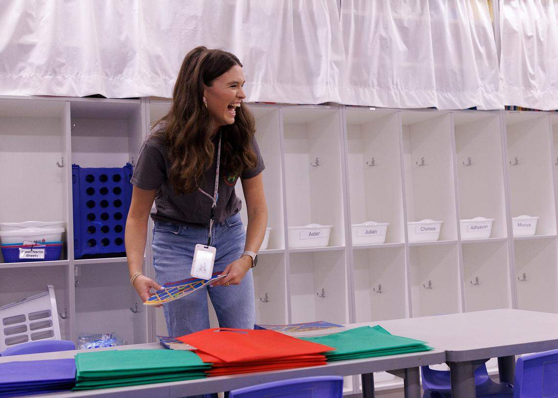 Emily Brugler, a first-year pre-kindergarten teacher, smiles while preparing supplies in her classroom at South Lakes Elementary School on Thursday, Aug. 22, 2024, in Fuquay-Varina, N.C.