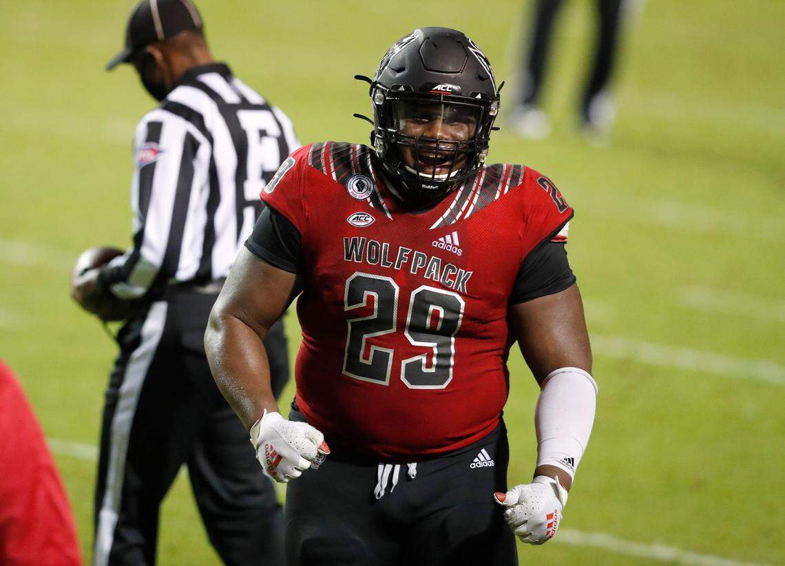 N.C. State defensive tackle Alim McNeill (29) celebrates after Florida State turned the ball over on downs during the second half of N.C. State’s 38-22 victory over Florida State at Carter-Finley Stadium in Raleigh, N.C., Saturday, Nov. 14, 2020.