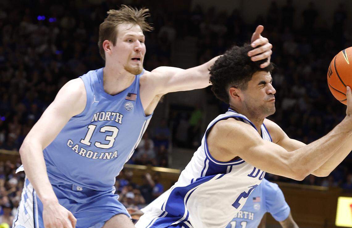 Duke’s Cayden Boozer (2) pulls in the loose ball in front of North Carolina's Henri Veesaar (13) during the second half of Duke’s 76-61 victory over UNC at Cameron Indoor Stadium in Durham, N.C., Saturday, March 7, 2026.
