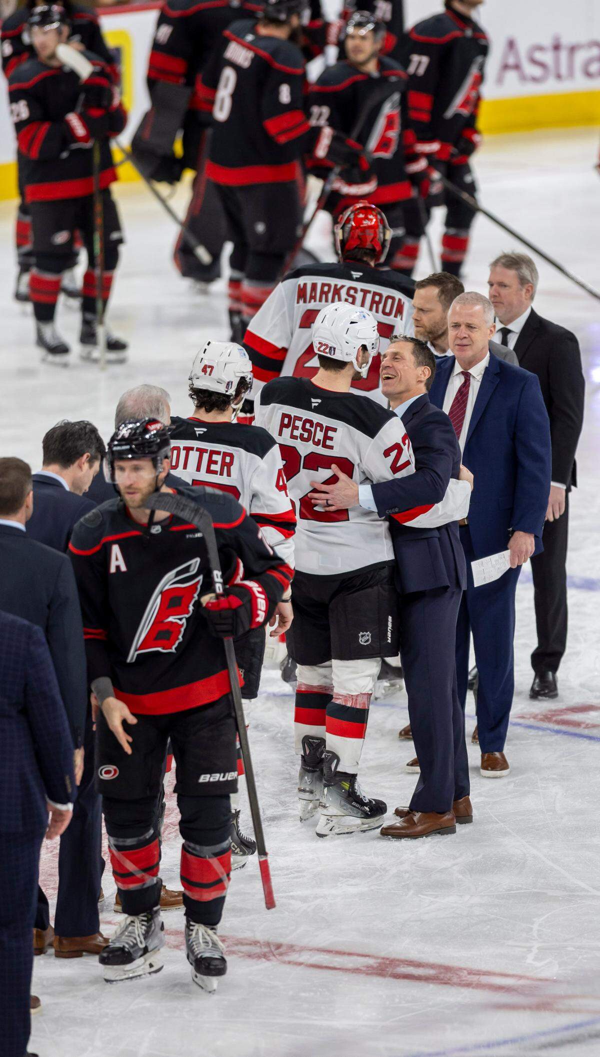 Carolina Hurricanes coach Rod Brind’Amour embraces former Carolina Hurricane, New Jersey Devils’ defenseman Bret Pesce (22) following the Hurricanes’ 5-4 victory on Tuesday, April 29, 2025 at Lenovo Center in Raleigh, N.C.