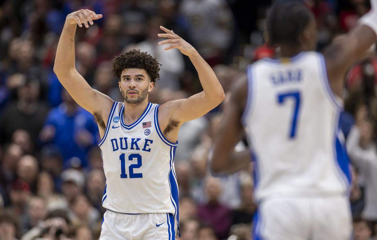 Duke forward Cameron Boozer (12) and guard Dame Sarr (7) organize their teammates for the final seconds of play against St. John’s on Friday, March 27, 2026, during the Sweet Sixteen of the NCAA Tournament at Capital One Arena in Washington, D.C.