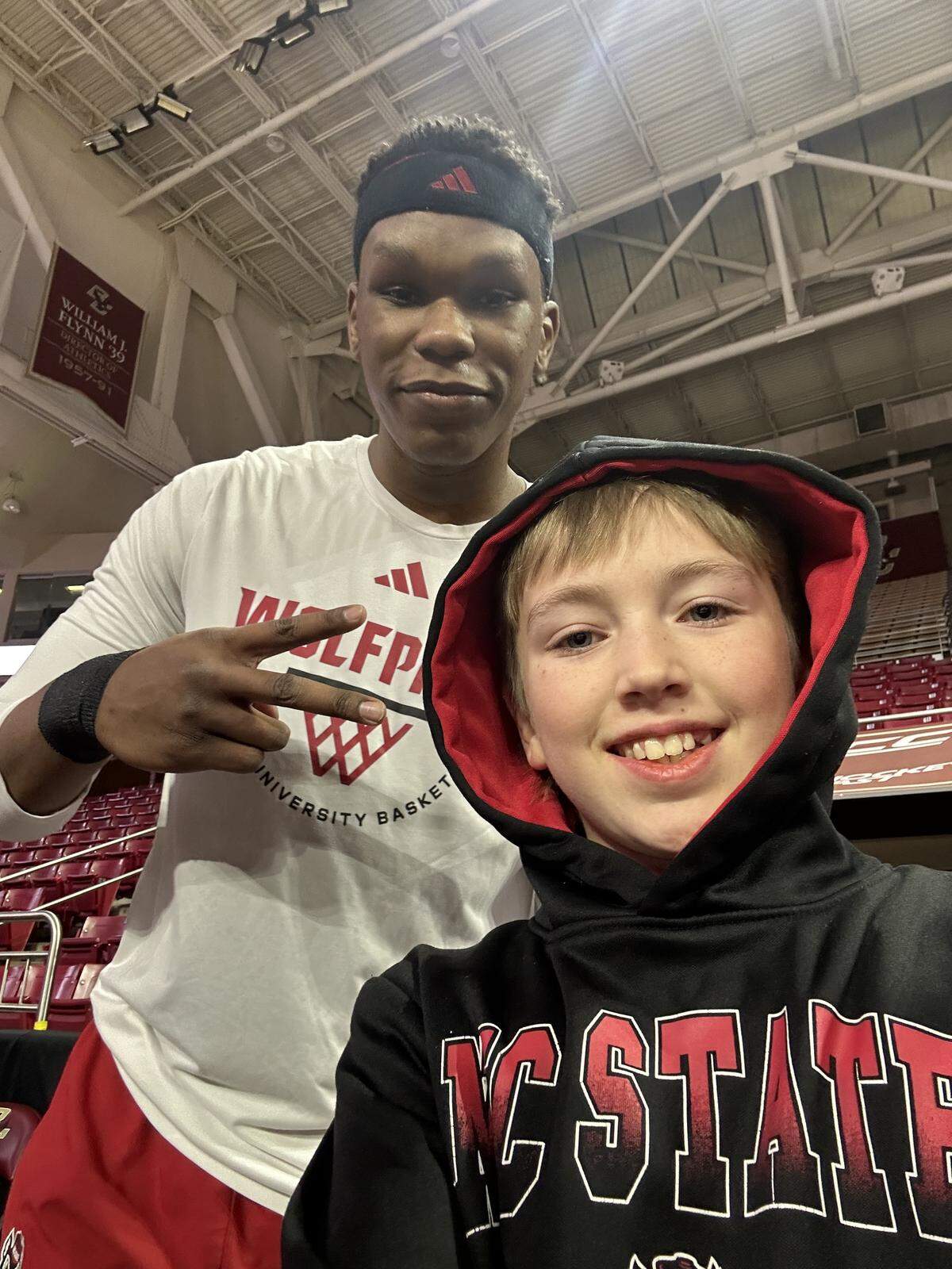 N.C. State’s Ven-Allen Lubin takes a selfie with Finley Hall ahead of the Wolfpack’s men’s basketball game at Boston College on Jan. 6, 2026, in Chestnut Hill, Mass.