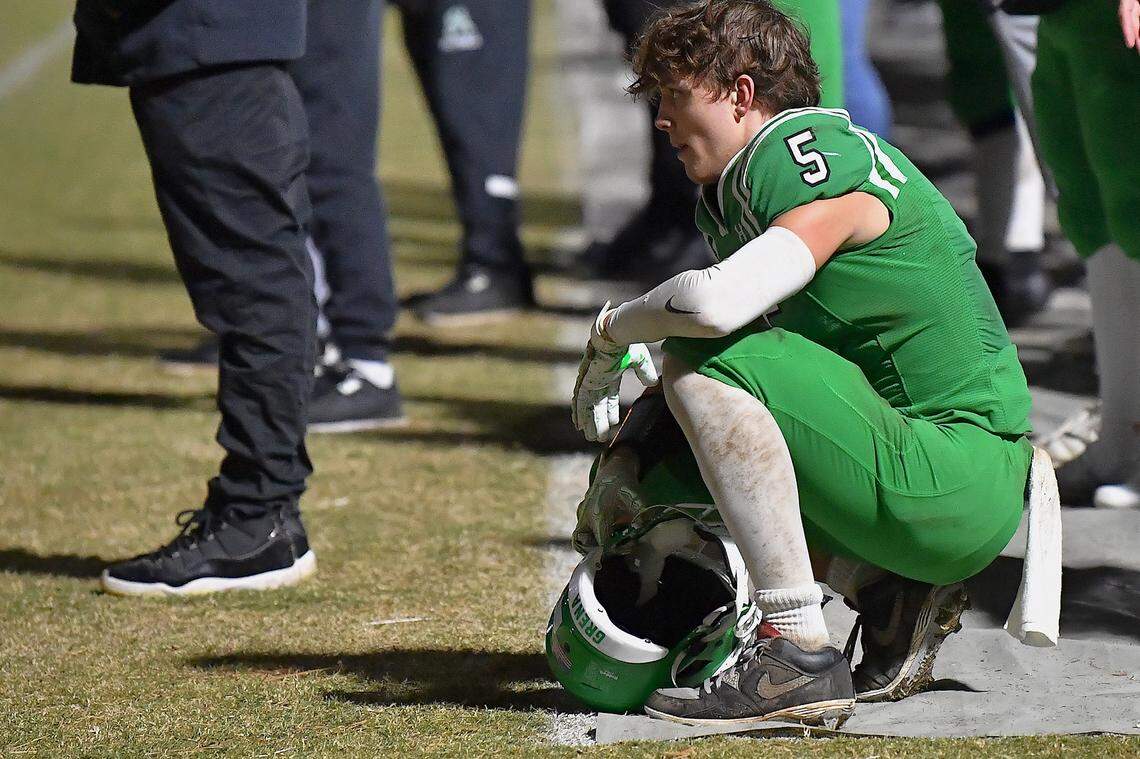 Cary's Erich Grena (5) kneels on the sidelines in the second half in the final minutes of their game with Middle Creek. The Cary Imps and the Middle Creek Mustangs met in a conference football game in Cary, N.C. on October 24, 2025