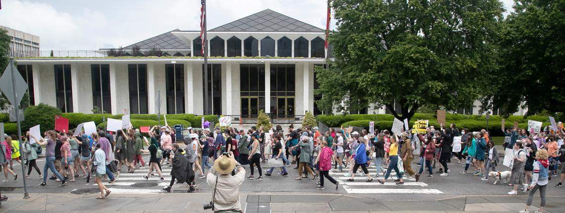 Abortion rights protesters march past the State Legislative Building in Raleigh, N.C. during the Bans Off Our Bodies abortion rights march and rally Saturday, May 14, 2022.
