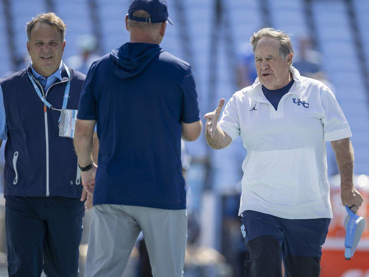 North Carolina coach Bill Belichick greets Richmond head coach Russ Huesman prior to the Tar Heels’ game against the Spiders on Saturday, September 13, 2025 at Kenan Stadium in Chapel Hill, N.C.