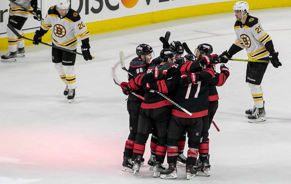 Carolina Hurricanes’ Nino Niederreiter (21) surrounded by teammates after scoring to to take 2-0 lead against Boston in the second period on Monday, May 2, 2022 during game one of their Stanley Cup first round series at PNC Arena in Raleigh, N.C