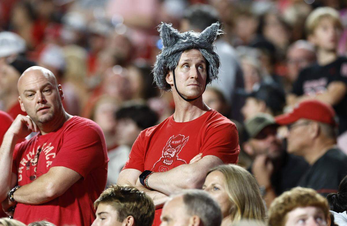 A Wolfpack fan looks up at the scoreboard during the second half of Virginia Tech’s 23-21 victory over N.C. State at Carter-Finley Stadium in Raleigh, N.C., Saturday, Sept. 27, 2025.