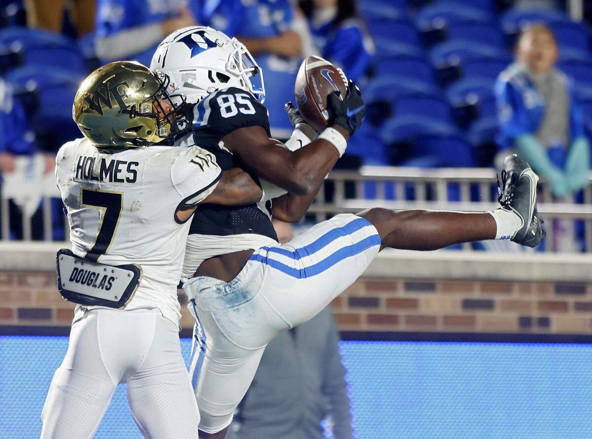 Duke’s Sahmir Hagans catches a pass over Wake Forest’s Gavin Holmes for a touchdown to give the Blue Devils a 34-31 lead with a little over two minutes remaining in Duke’s final regular season game at Wallace Wade Stadium on Saturday, Nov. 26, 2022, in Durham, N.C.