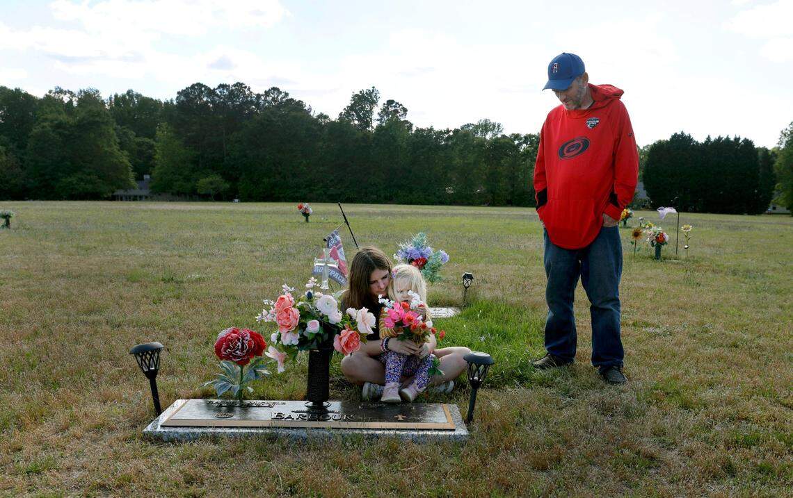 Van Barbour his daughters, Maddie, 12, and Oakleigh, 2, visit the grave of his wife and their mother Rachel at Greenlawn Memorial Gardens in Fuquay-Varina, N.C.