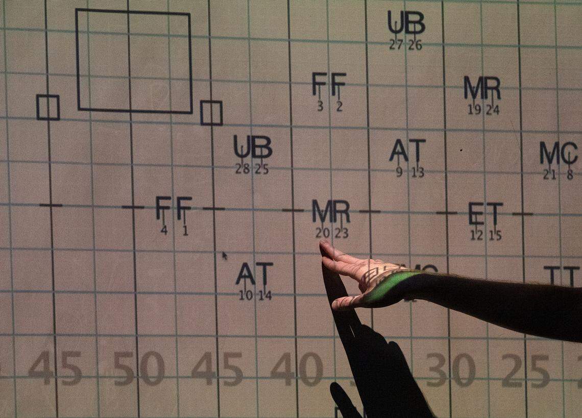 Cameron Garris, Director of Bands at Jordan High School, teaches students how to read drill during the first day of marching band camp on Monday, July 22, 2024, in Durham, N.C.