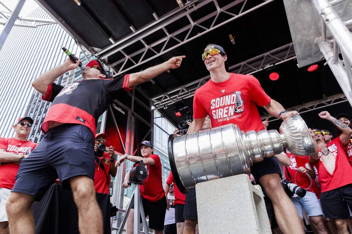Carolina's Andrei Svechnikov (37) prepares to lift the Stanley Cup during a rally on Saturday, June 20, 2026, in downtown Raleigh.