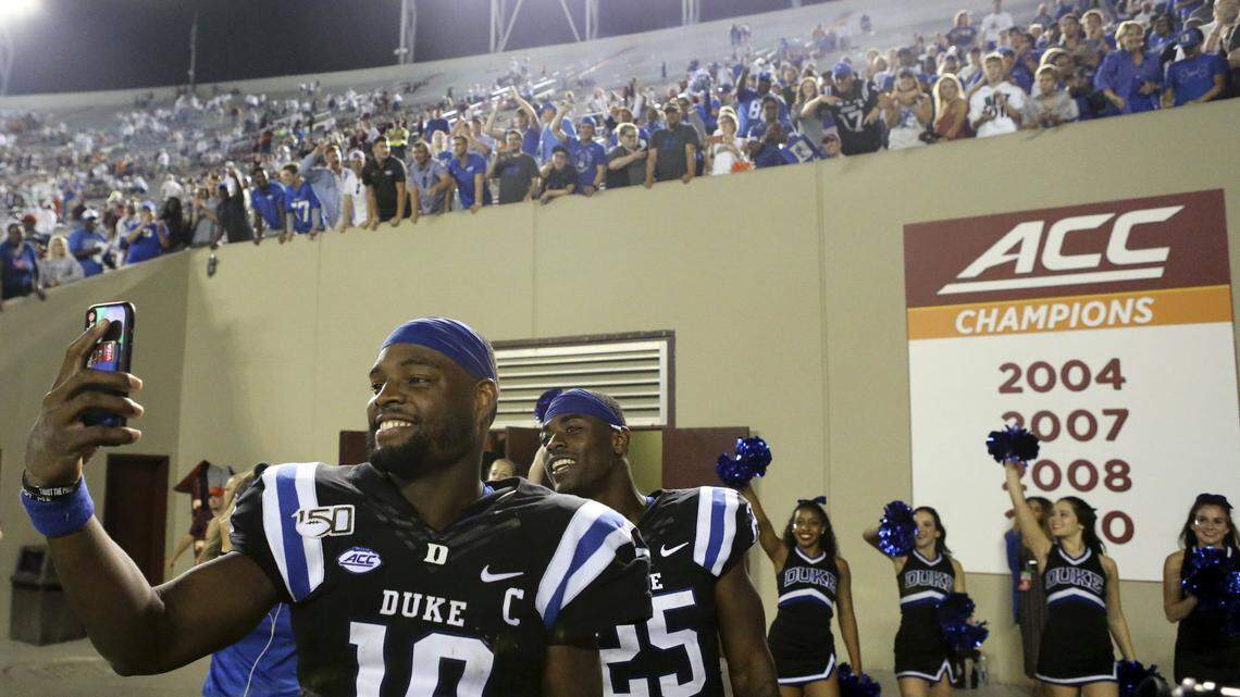 Duke quarterback Quentin Harris (18) and running back Deon Jackson (25) celebrate at the conclusion of an NCAA college football game against Virginia Tech, Friday, Sept. 27, 2019, in Blacksburg, Va. Duke won 45-10.