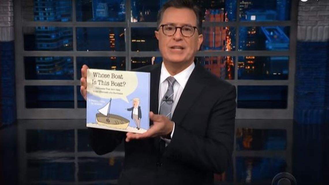 On his CBS show “The Late Show with Stephen Colbert,” host Stephen Colbert holds up a copy of a children’s book about Donald Trump’s Sept. 19 visit to North Carolina, “Whose Boat is This Boat?”