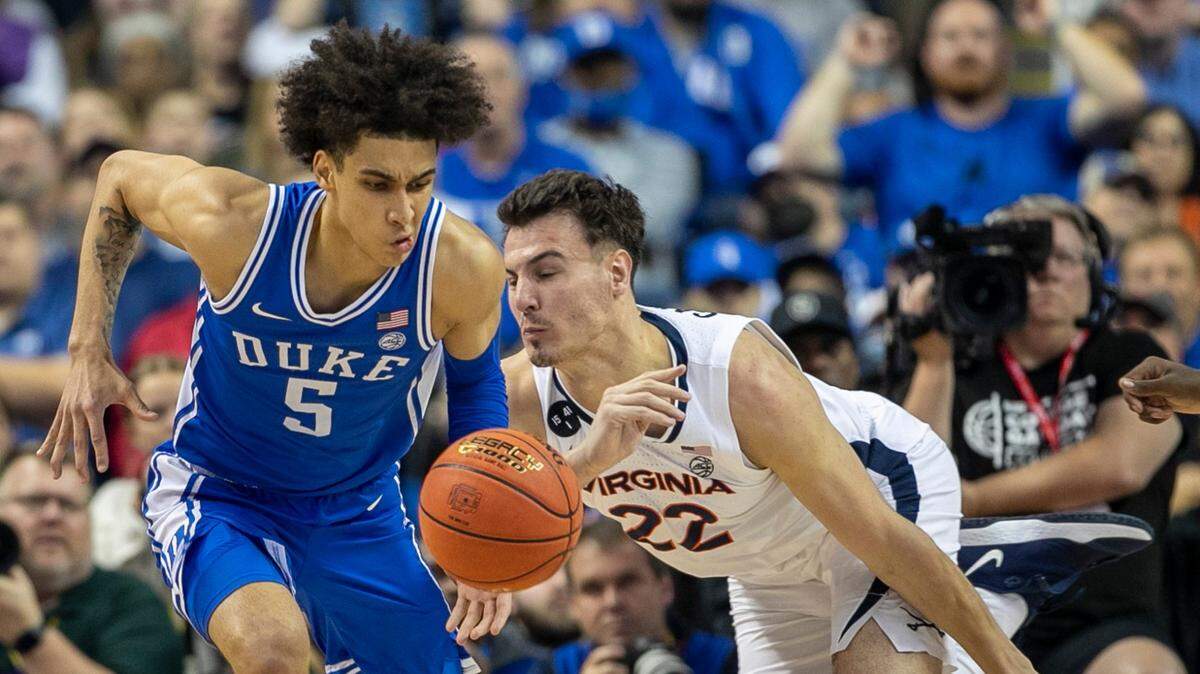 Duke’s Tyrese Proctor (5) makes a steal from Virginia’s Francisco Caffaro (22) during the first half in the championship game of the ACC Tournament on Saturday, March 11, 2023 at the Greensboro Coliseum in Greensboro, N.C