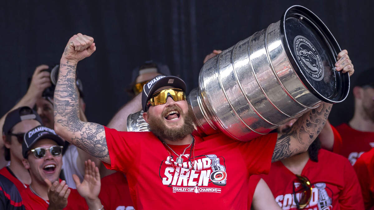 Carolina Hurricanes left wing Nicolas Deslauriers hoists the Stanley Cup, during the rally on the City Plaza on Saturday, June 20, 2026 in Raleigh, NC.