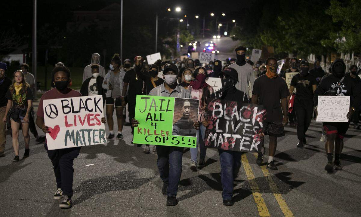 Protesters march along E. Main Street in Durham, N.C. on Monday night June 1, 2020, during an evening of peaceful protest that spanned most of downtown, honoring the life of George Floyd.