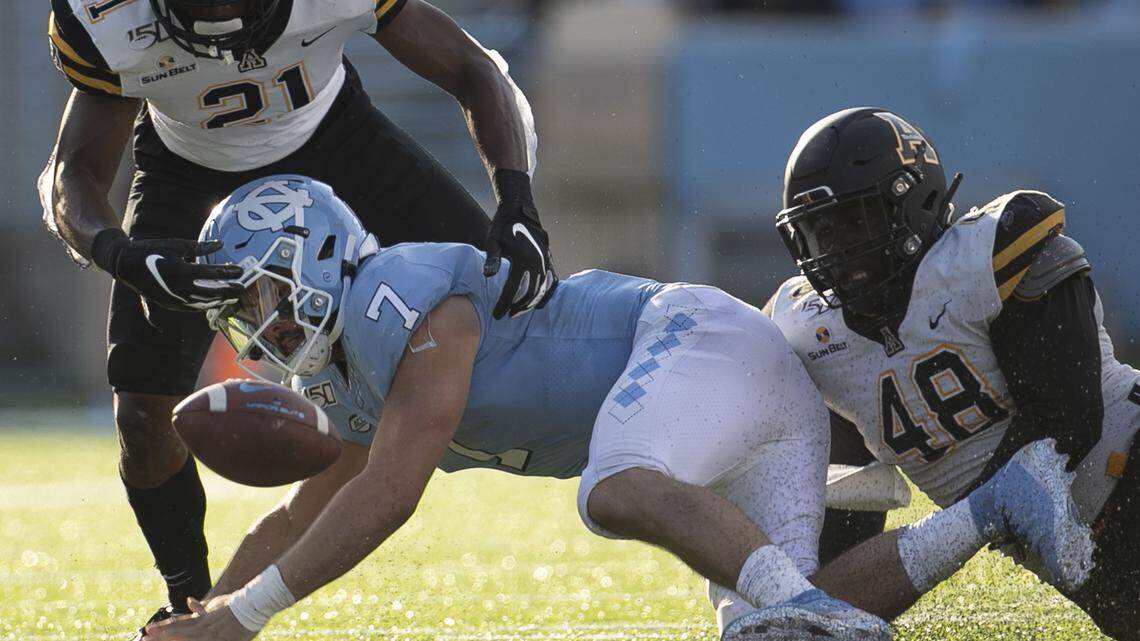 Appalachian State’s Ryan Huff (21) and Demetrius Taylor (48) sack North Carolina quarterback Sam Howell (7) for a loss of three yards and force a fumble which North Carolina recovered in the third quarter on Saturday, September 21, 2019 at Kenan Stadium in Chapel Hill, N.C.
