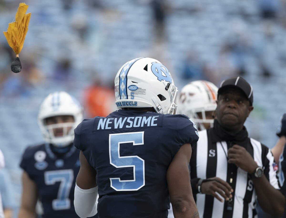 North Carolina’s Dazz Newsome (5) is called for unsportsmanlike conduct after scoring a touchdown on a six-yard carry in the second quarter against Virginia Tech ‘s Devin Taylor (24) to give the Tar Heels’ a 28-14 lead on Saturday, October 10, 2020 at Kenan Stadium in Chapel Hill, N.C.