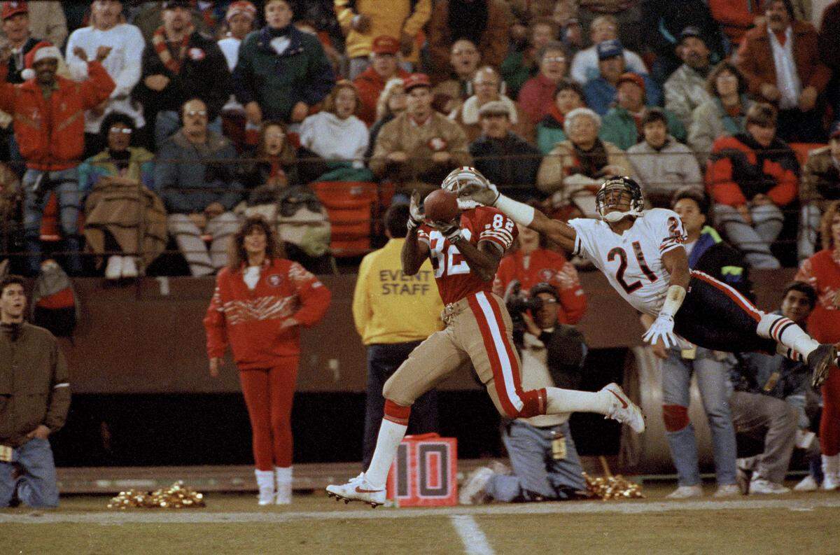 Wide Receiver John Taylor of the San Francisco 49ers, has a pass from quarterback Steve Young knocked away by cornerback Donnell Woolford (21) of the Chicago Bears, during the third quarter at Candlestick Park in San Francisco, Calif., Dec. 24, 1991.