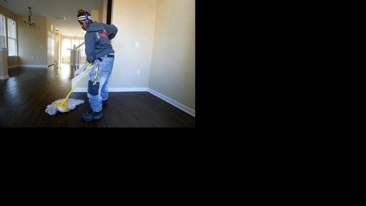 Rodrick Powers applies floor finish in a new townhouse at Walnut Terrace. The redevelopment, with plans to open in early February with 292 townhouses, houses and apartments. Less than half will be traditional public housing; the rest will leasefrom $775 to $1,100 monthly.
