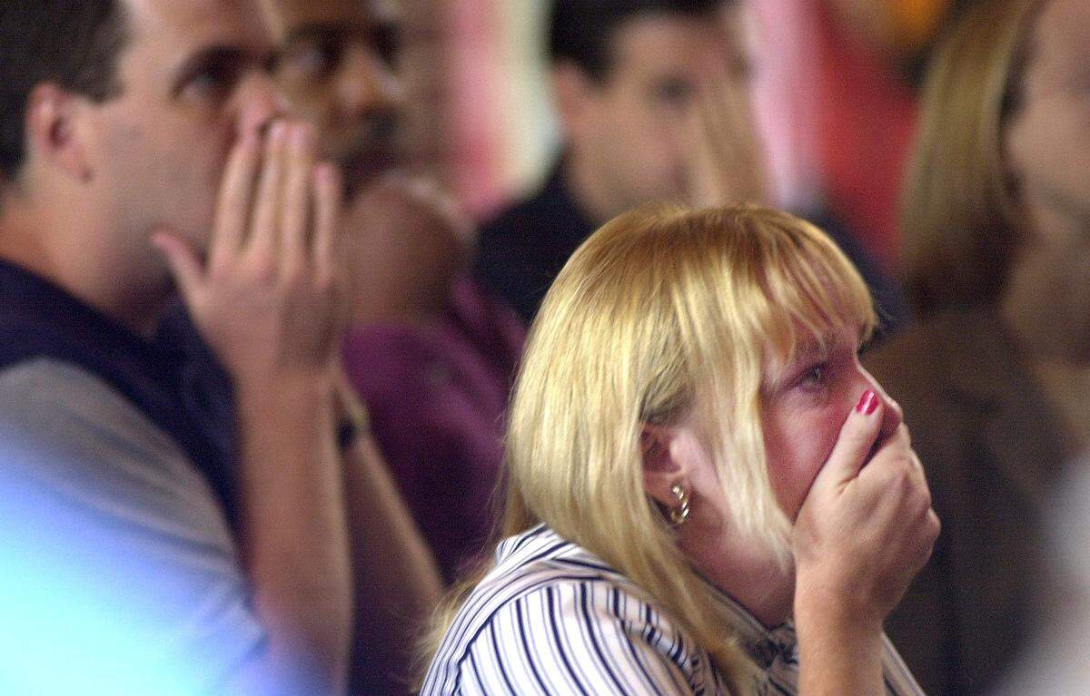 Marcee Holmes can’t hold her tears while watching television at Raleigh’s Sheraton Hotel of the World Trade Center terrorist attack Tuesday morning, Sept 11, 2001. “I’m stunned, amazed, this is surreal, like if I were watching a movie. I’m shaking, I can’t stop crying. My eyes are glued to the TV, I’m in mourning for anyone who died, so much happened so fast...”, Holmes says.