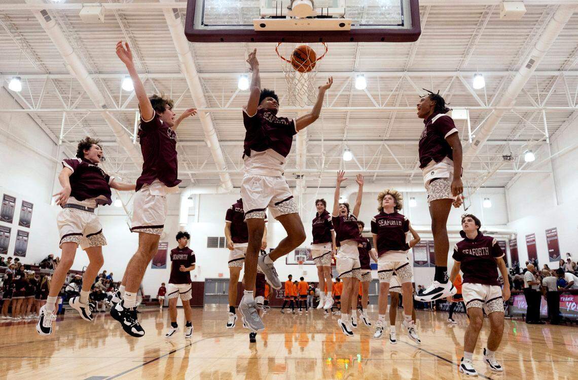A the conclusion of their pre-game warm ups, Jarin Stevenson leads his teammates through their ritual of running to the basket together for a final dunk before their game against Bartlett Yancey High School on December 16, 2022 at Seaforth High School in Pittsboro, N.C.