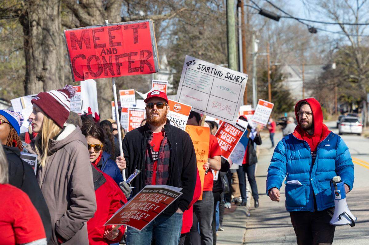 Durham County Public Schools staff, parents and community members rally and picket outside DPS’s Fuller Building in downtown Durham Monday, Feb. 5, 2024. Salary issues have plunged the district into chaos. The issues stem from an accounting error that resulted in administration withdrawing raises promised to 1,300 school staff, prompting protests and strikes since mid-January.