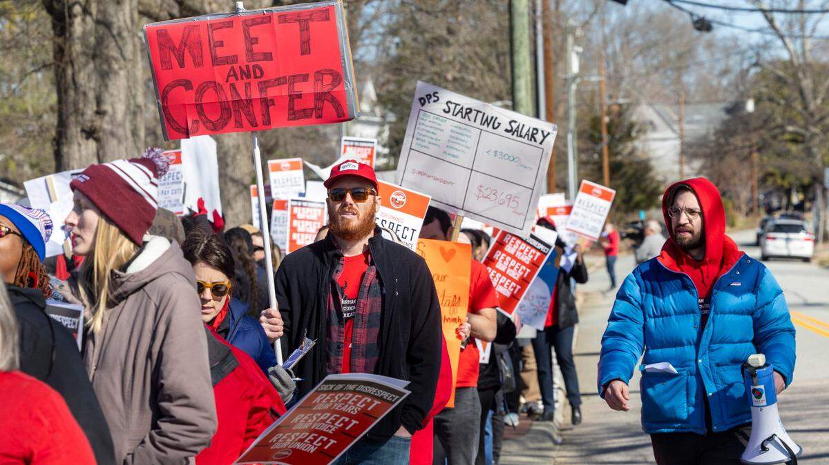 Durham County Public Schools staff, parents and community members rally and picket outside DPS’s Fuller Building in downtown Durham Monday, Feb. 5, 2024. Salary issues have plunged the district into chaos. The issues stem from an accounting error that resulted in administration withdrawing raises promised to 1,300 school staff, prompting protests and strikes since mid-January.