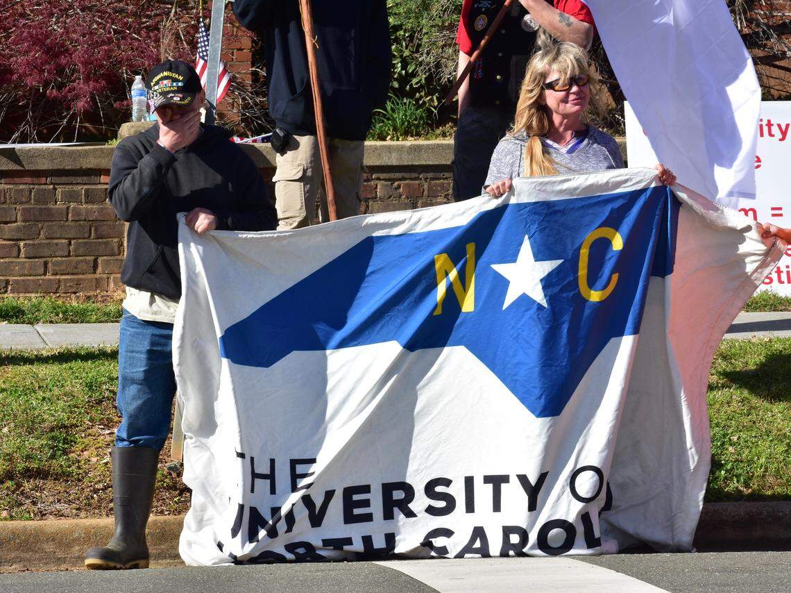 Protesters hold a UNC System flag outside the Whitted Building in Hillsborough March 31 when Palestinian-American activist Linda Sarsour talked.