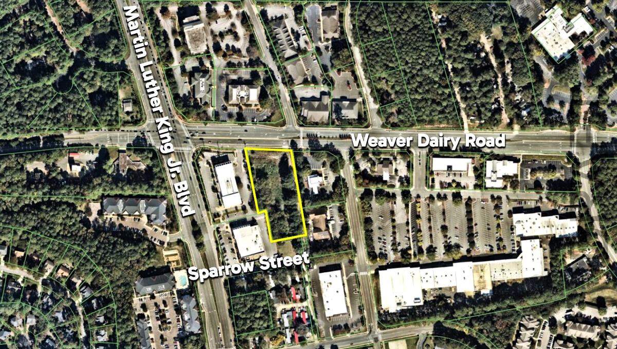 A Montessori school previously occupied the narrow lot at 1165 Weaver Dairy Road in Chapel Hill (outlined in yellow). A proposed plan would add a new daycare with a playground, 34 parking spaces and four, two-story townhomes.